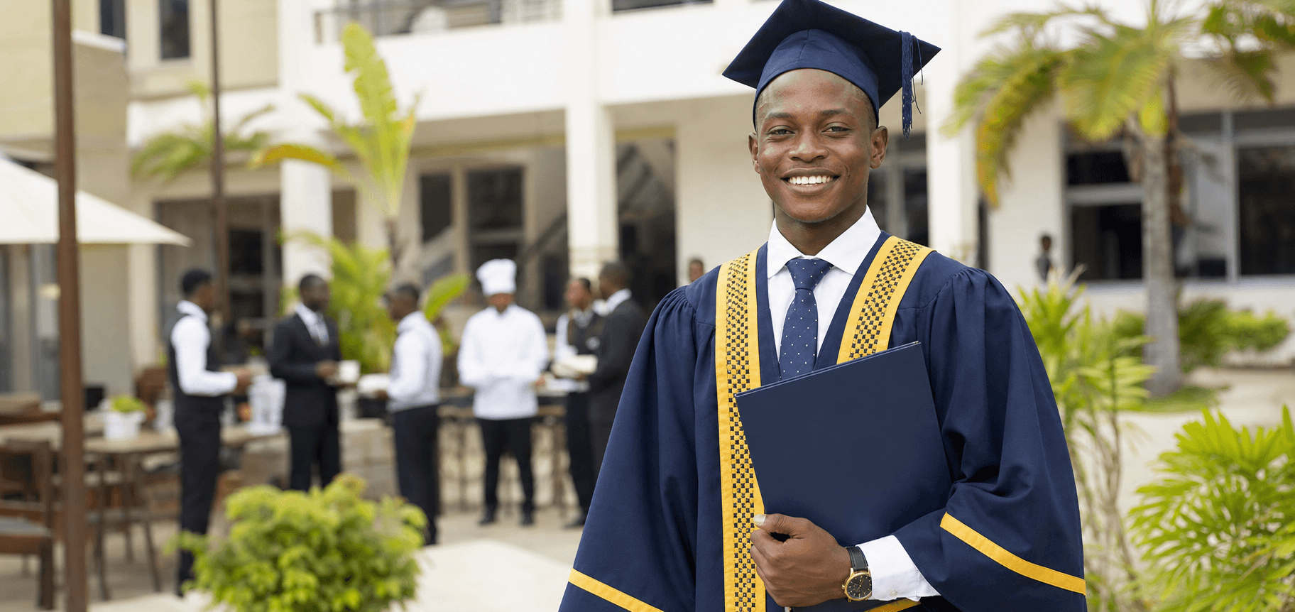 A HOTCATT-ABE graduate holding a diploma on campus.