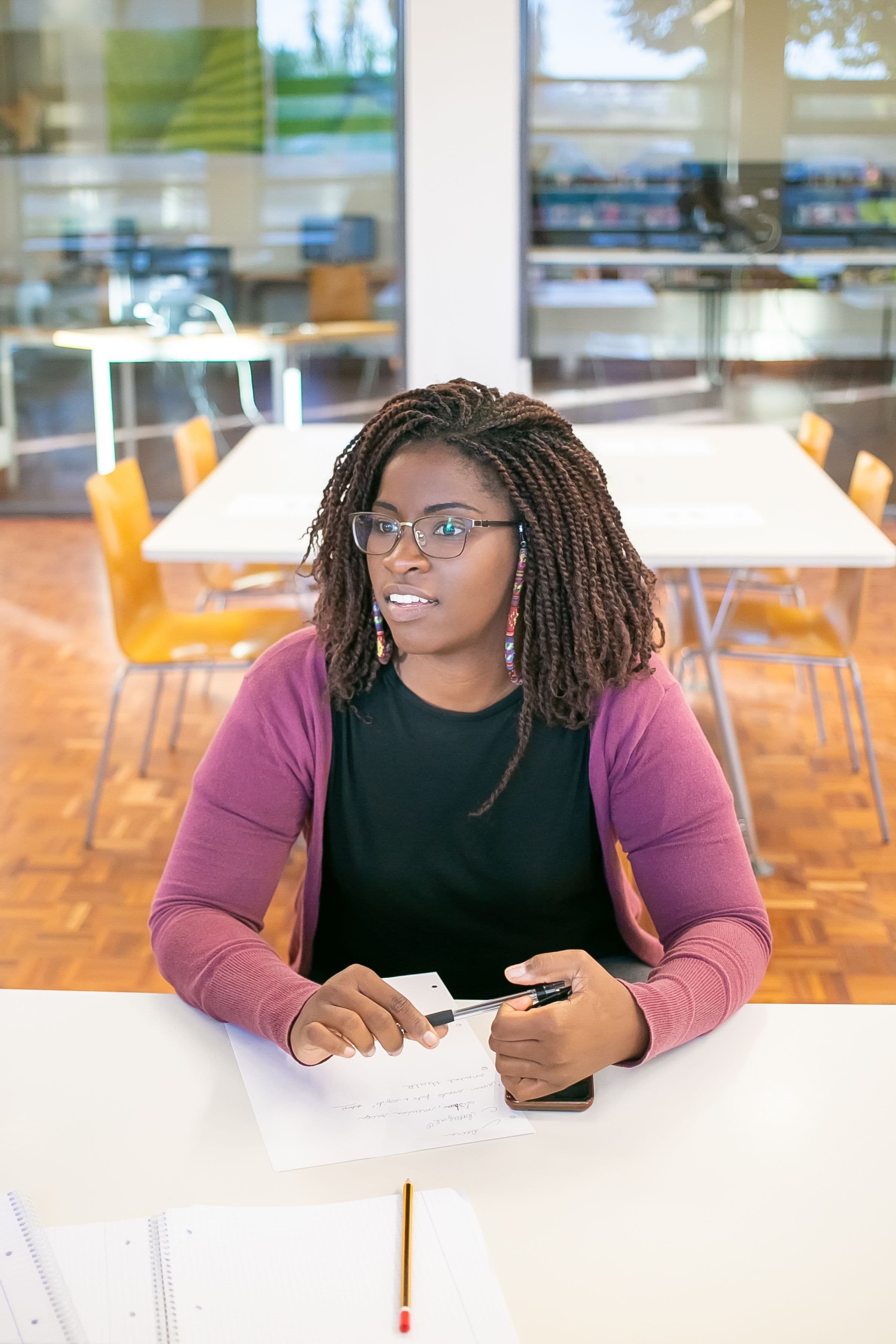 Student seated in a classroom learning environment.